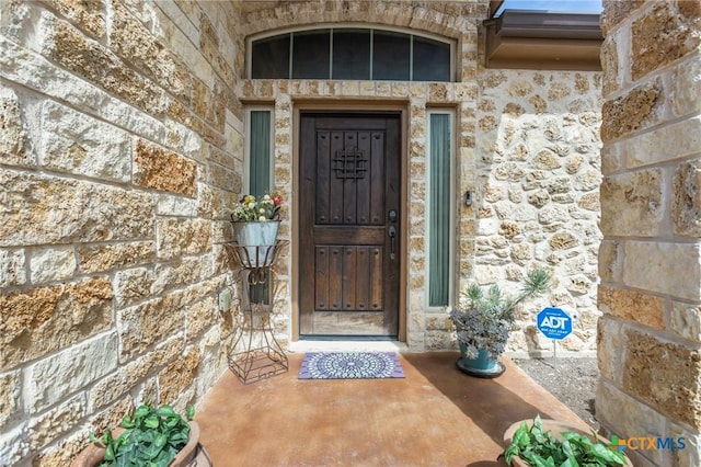 entrance to property with stone siding