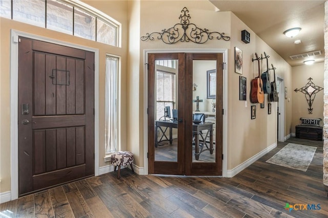 entryway featuring dark wood-style floors, visible vents, and french doors