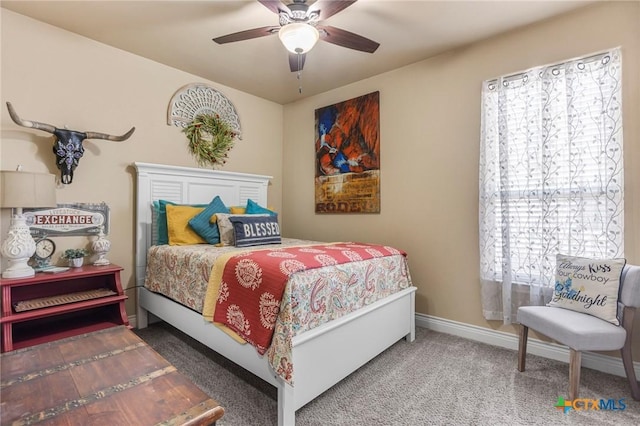 bedroom featuring a ceiling fan, baseboards, and carpet floors