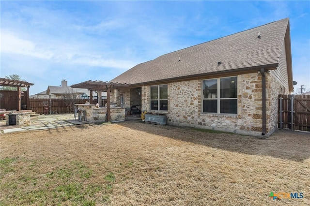 back of property featuring a patio area, stone siding, a pergola, and a fenced backyard