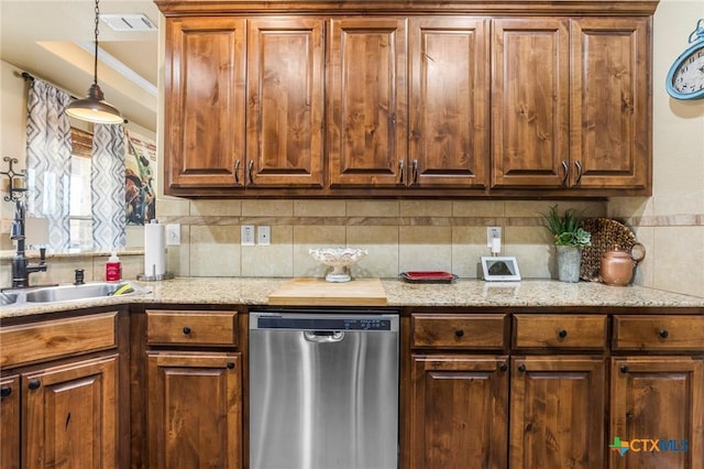 kitchen with visible vents, pendant lighting, a sink, stainless steel dishwasher, and decorative backsplash