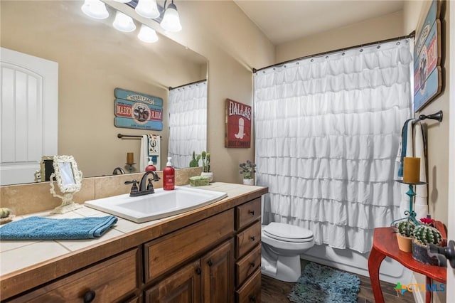 full bathroom with shower / tub combo, toilet, and vanity