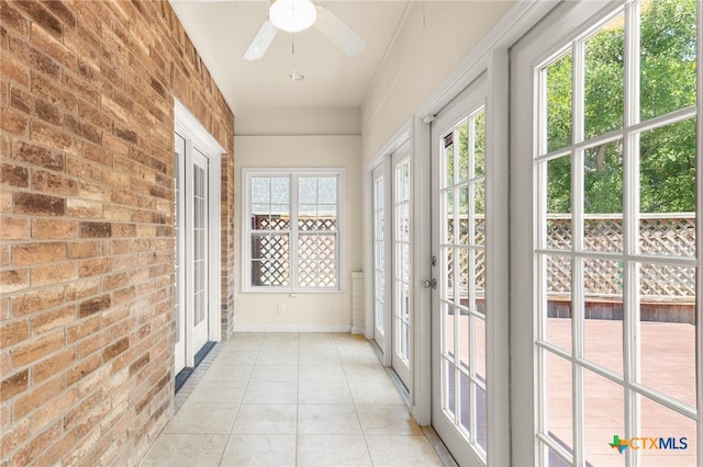 217 Ciela Vis, Seguin, TX 78155 - unfurnished sunroom with french doors, tile patterned flooring, brick wall, and baseboards