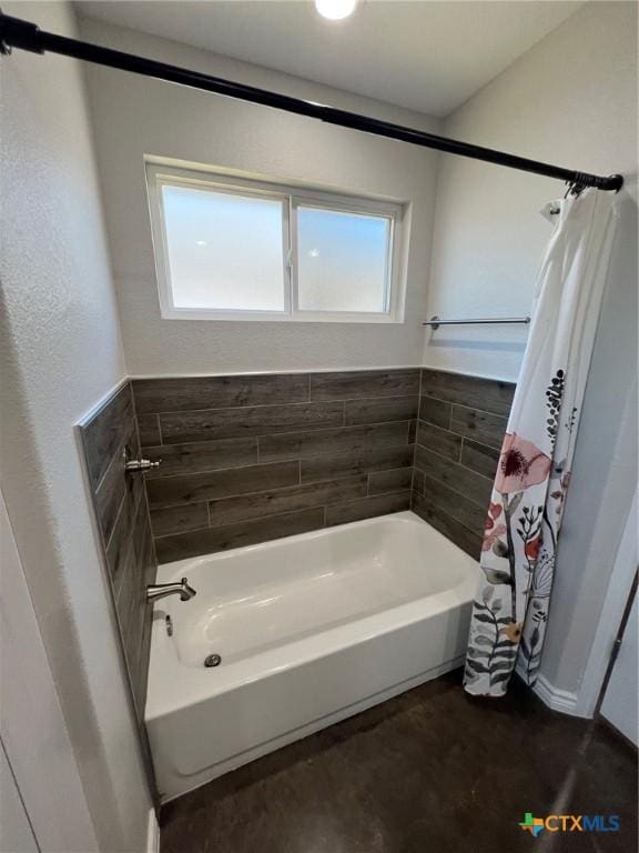 bathroom with a shower with curtain and a bathtub