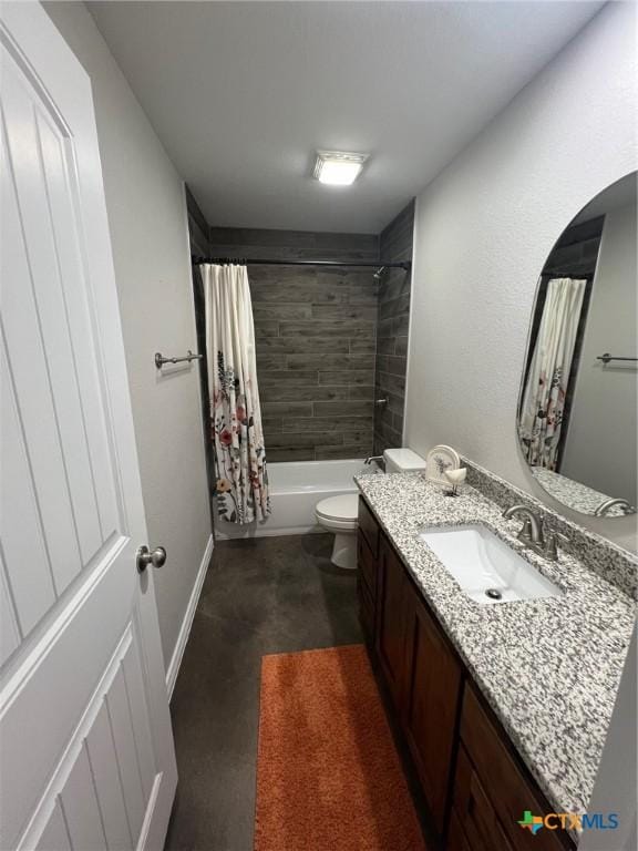 bathroom featuring toilet, vanity, shower / tub combo, and baseboards