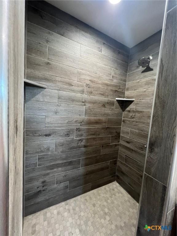 full bath with a tile shower