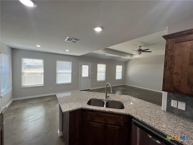 kitchen with visible vents, open floor plan, a wealth of natural light, and a sink