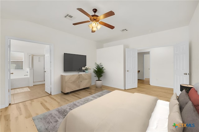 bedroom featuring connected bathroom, ceiling fan, hardwood / wood-style floors, and vaulted ceiling