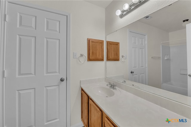 bathroom with bathtub / shower combination and vanity