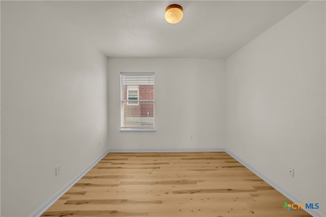 unfurnished room with hardwood / wood-style flooring