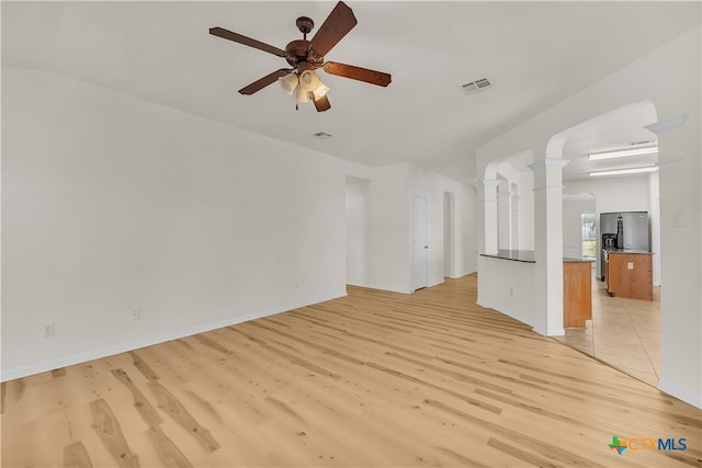 unfurnished living room with ceiling fan and light hardwood / wood-style flooring