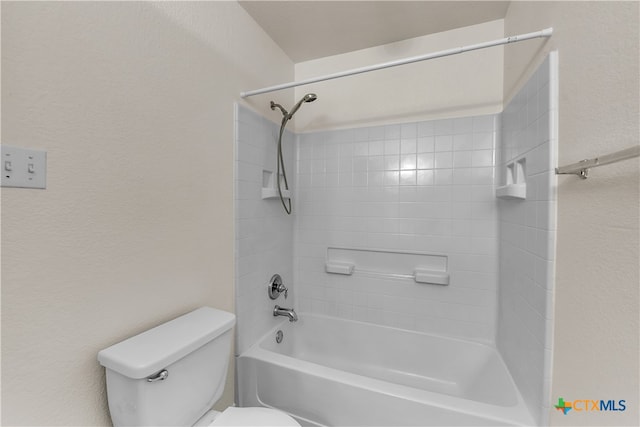 bathroom featuring toilet and tiled shower / bath