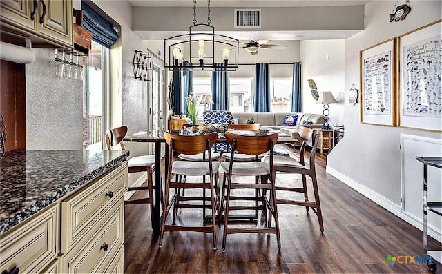 1265 N Ocean Dr, Port Lavaca, TX 77979 - dining room with baseboards, a healthy amount of sunlight, dark wood-type flooring, and visible vents