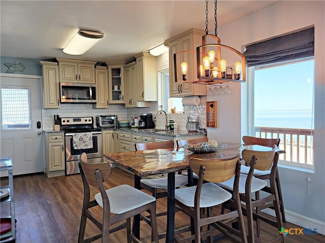 1265 N Ocean Dr, Port Lavaca, TX 77979 - dining area featuring dark wood-style flooring, a chandelier, and a toaster
