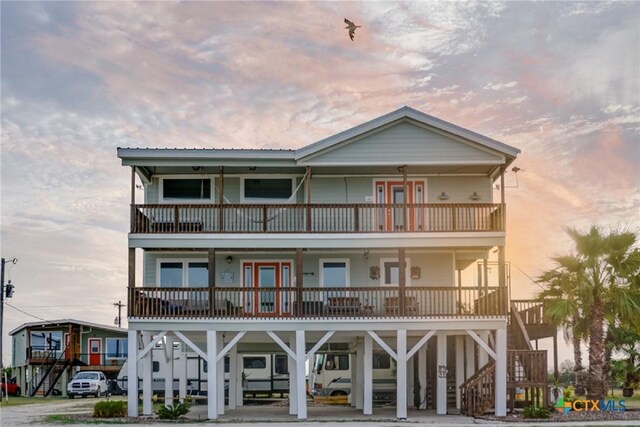 1265 N Ocean Dr, Port Lavaca, TX 77979 - exterior space featuring a carport, a porch, a balcony, and stairs