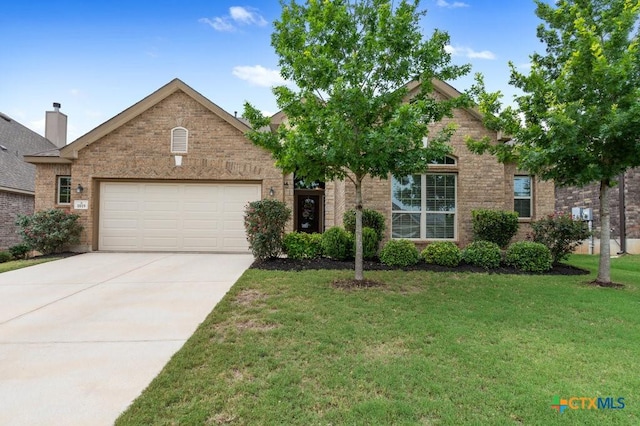 view of front of property with a front lawn and a garage