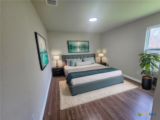 bedroom with dark wood-type flooring