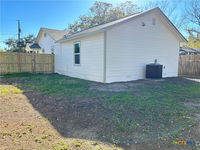 view of home's exterior with central AC and a lawn