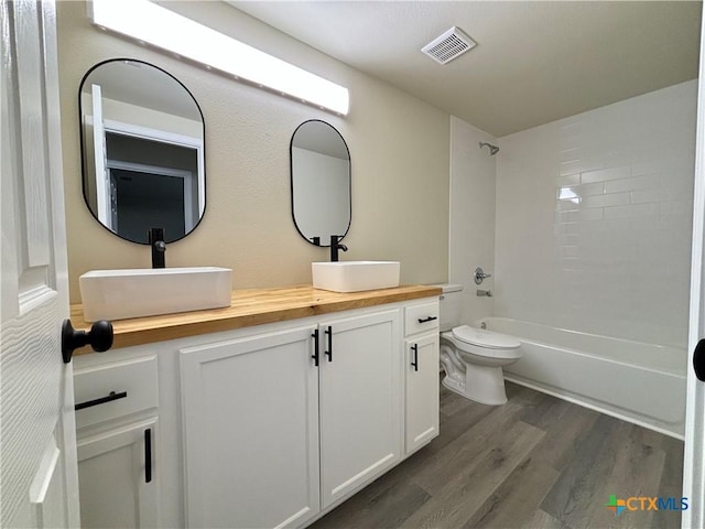 kitchen featuring decorative backsplash, white cabinetry, dark wood-type flooring, and sink