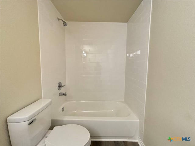 bathroom featuring wood-type flooring, bathtub / shower combination, and toilet