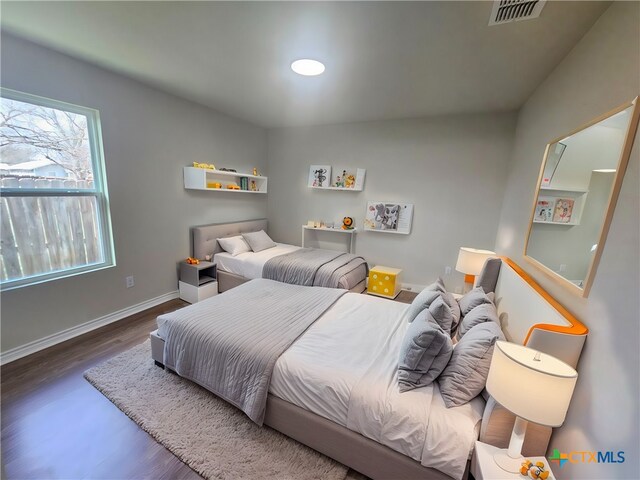 bedroom featuring dark hardwood / wood-style flooring