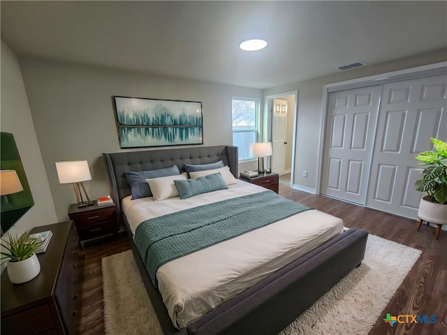 bedroom featuring dark hardwood / wood-style flooring and a closet