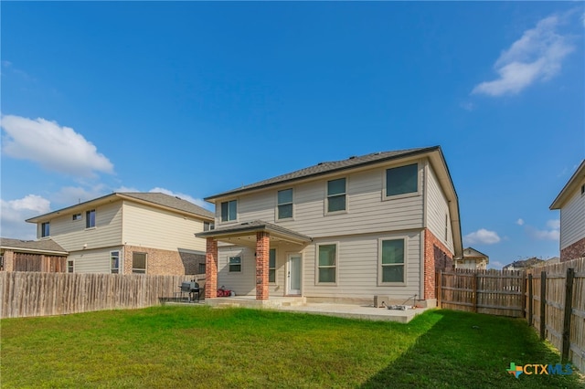 back of property featuring a patio area and a yard