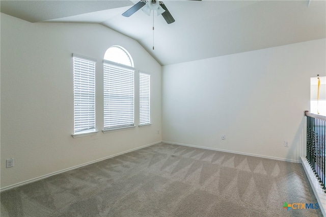 carpeted spare room with lofted ceiling and ceiling fan