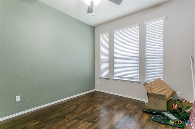 spare room with ceiling fan and dark hardwood / wood-style floors