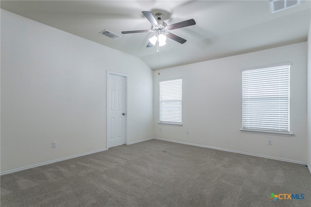 carpeted empty room with ceiling fan and lofted ceiling