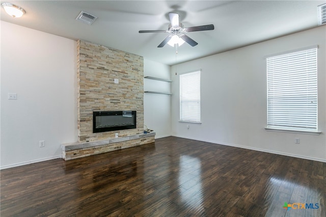 unfurnished living room with a wealth of natural light, ceiling fan, and dark hardwood / wood-style flooring