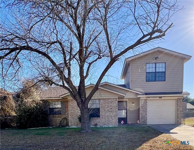 view of front of property with a garage and a front lawn