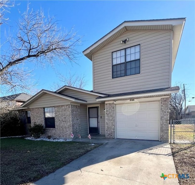 view of property with a garage and a front lawn