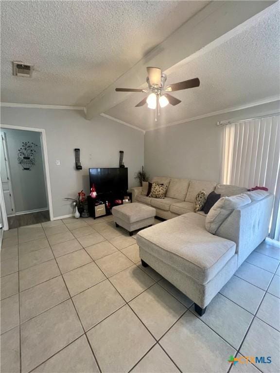 living room with lofted ceiling with beams, light tile patterned floors, ceiling fan, crown molding, and a textured ceiling