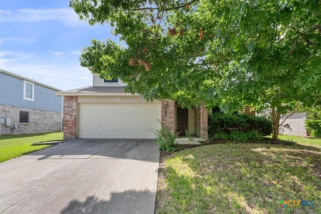 5407 Whistle Stop Dr, Temple, TX 76502 - obstructed view of property with brick siding, concrete driveway, a garage, and a front lawn