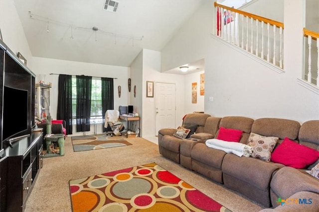 5407 Whistle Stop Dr, Temple, TX 76502 - carpeted living area with high vaulted ceiling and track lighting