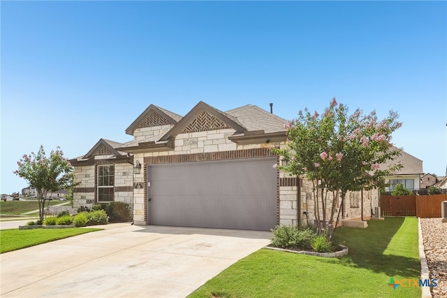 156 High Plains Dr, Georgetown, TX 78628 - french country inspired facade featuring stone siding, an attached garage, and driveway