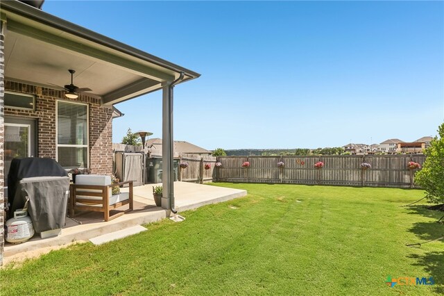 156 High Plains Dr, Georgetown, TX 78628 - fenced backyard featuring a patio area and ceiling fan