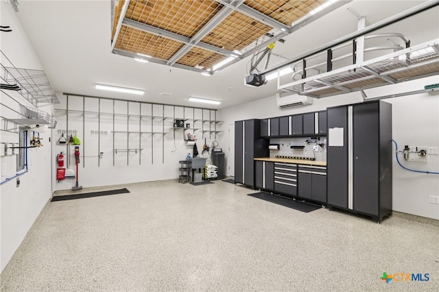 156 High Plains Dr, Georgetown, TX 78628 - garage with a garage door opener and a wall mounted air conditioner