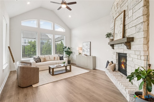 156 High Plains Dr, Georgetown, TX 78628 - living room with a ceiling fan, wood finished floors, a stone fireplace, and high vaulted ceiling