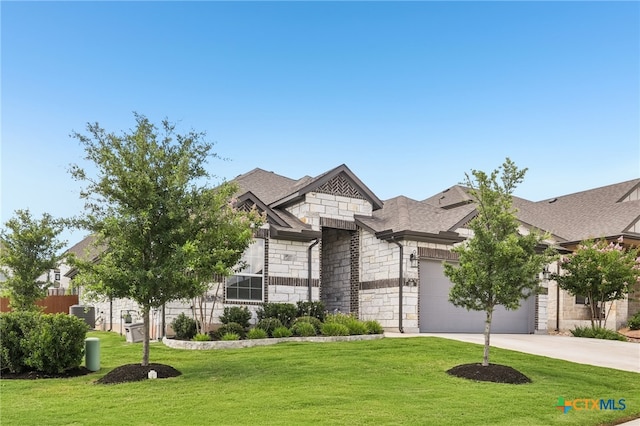 156 High Plains Dr, Georgetown, TX 78628 - view of front facade featuring stone siding, concrete driveway, a front yard, a garage, and a shingled roof
