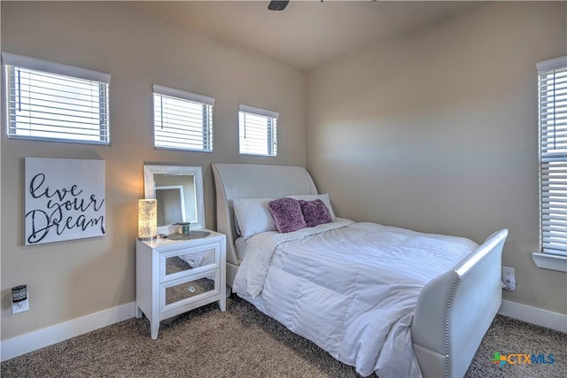 bedroom with carpet floors, multiple windows, and ceiling fan