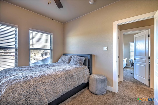 bedroom featuring ceiling fan and carpet