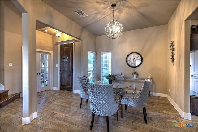 dining space with an inviting chandelier