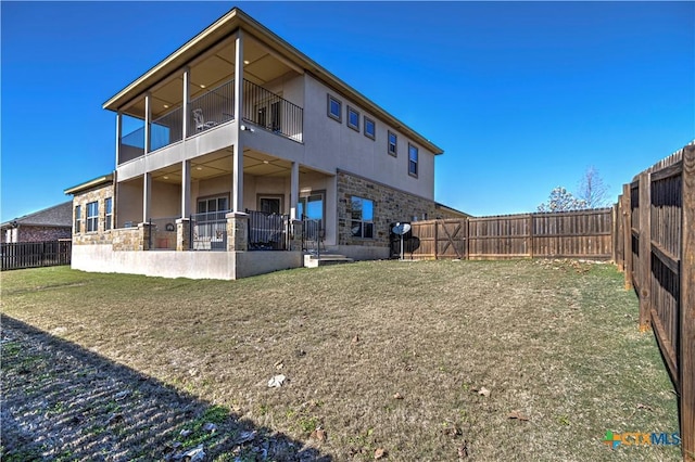 rear view of property with a lawn