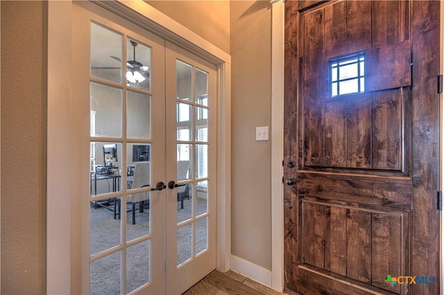 entryway with hardwood / wood-style floors, ceiling fan, and french doors