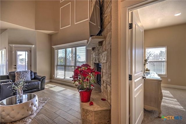 living room with a fireplace and plenty of natural light