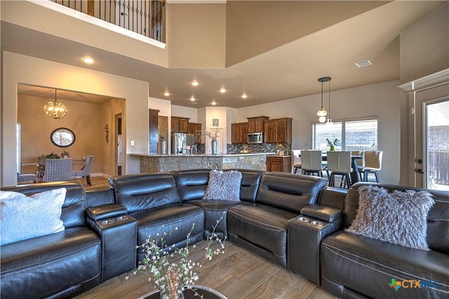 living room with a chandelier and a high ceiling