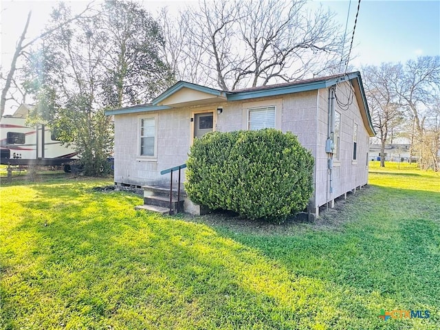 rear view of house with a yard