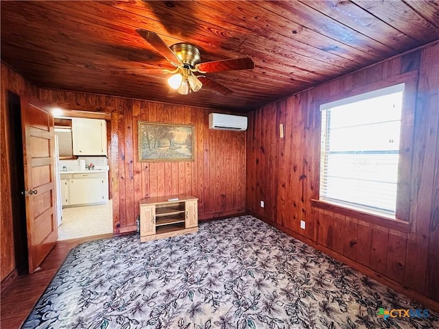 unfurnished room with an AC wall unit, wooden ceiling, a ceiling fan, and wooden walls